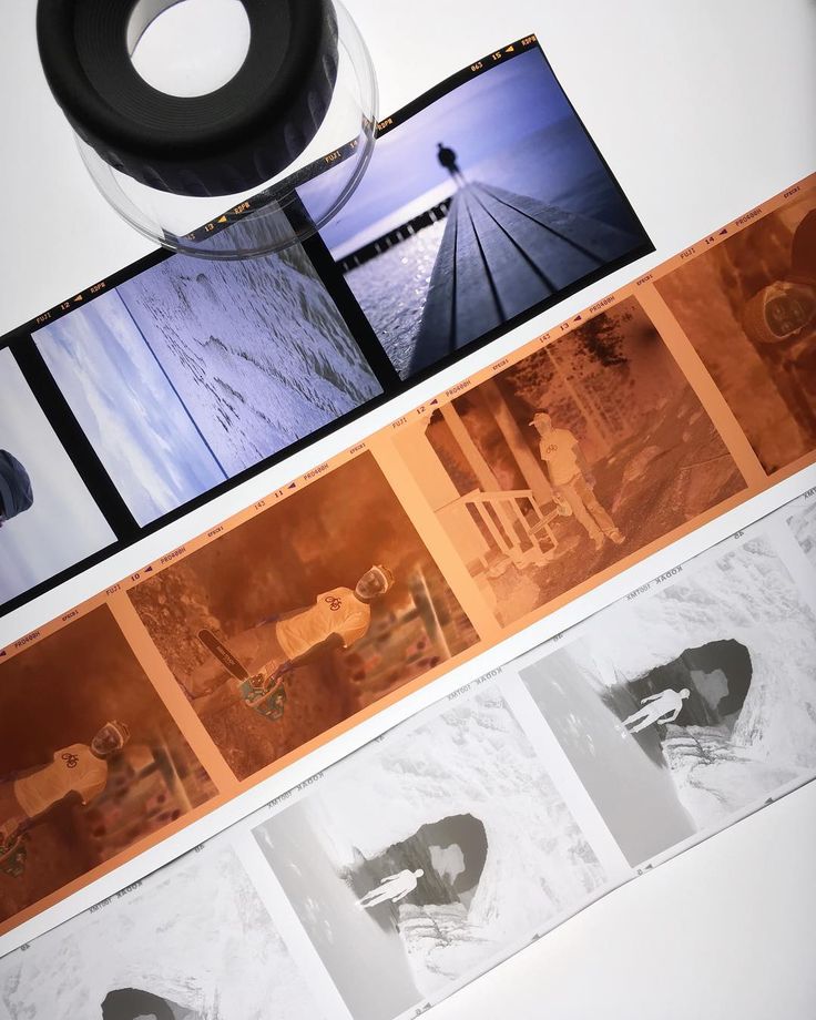 Strips of slide and negative film arranged beneath a magnifying loupe