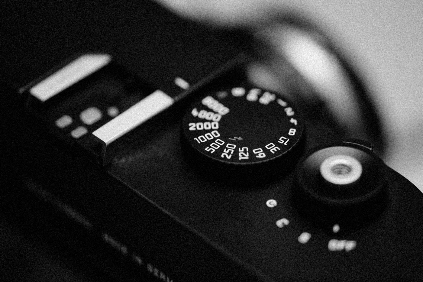 Black-and-white close-up of a camera ISO dial marked from 15 to 4000